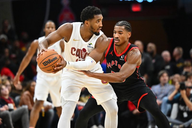 CLEVELAND, OHIO - NOVEMBER 24: Donovan Mitchell #45 of the Cleveland Cavaliers looks for a pass while under pressure from Ochai Agbaji #30 of the Toronto Raptors during the second half at Rocket Mortgage Fieldhouse on November 24, 2024 in Cleveland, Ohio. The Cavaliers defeated the Raptors 122-108.NOTE TO USER: User expressly acknowledges and agrees that, by downloading and or using this photograph, User is consenting to the terms and conditions of the Getty Images License Agreement. (Photo by Jason Miller/Getty Images)