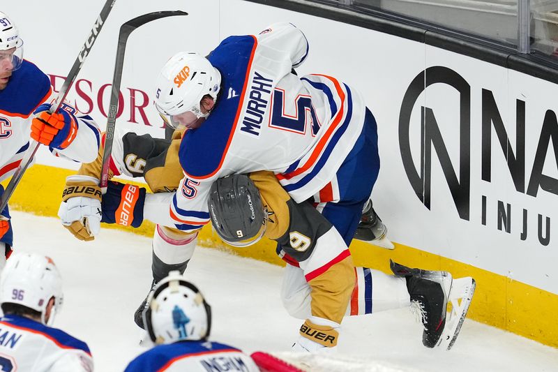 Mar 26, 2026; Las Vegas, Nevada, USA; Edmonton Oilers defenseman Connor Murphy (5) takes down Vegas Golden Knights center Jack Eichel (9) during the third period at T-Mobile Arena. Mandatory Credit: Stephen R. Sylvanie-Imagn Images