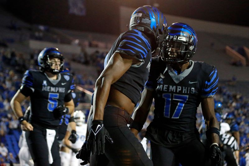 Nov 10, 2022; Memphis, Tennessee, USA; Memphis Tigers wide receiver Javon Ivory (4) and wide receiver Cameron Wright (17) react after an Ivory touchdown during the first half against the Tulsa Golden Hurricane at Liberty Bowl Memorial Stadium. Mandatory Credit: Petre Thomas-USA TODAY Sports