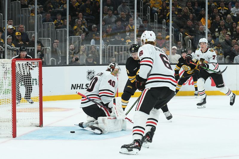 Oct 9, 2025; Boston, Massachusetts, USA; Boston Bruins center Elias Lindholm (28) looks for the puck behind Chicago Blackhawks goaltender Arvid Soderblom (40) during the third period at TD Garden. Mandatory Credit: Bob DeChiara-Imagn Images