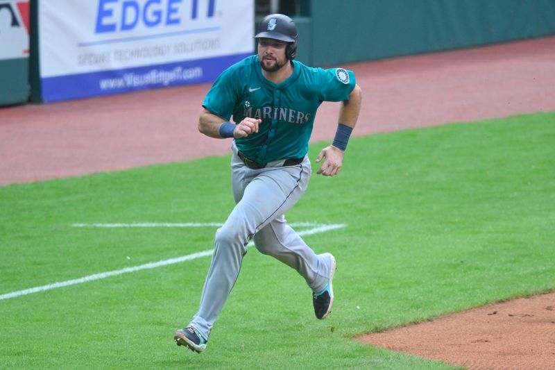 Jun 18, 2024; Cleveland, Ohio, USA; Seattle Mariners catcher Cal Raleigh (29) scores in the third inning against the Cleveland Guardians at Progressive Field. Mandatory Credit: David Richard-USA TODAY Sports