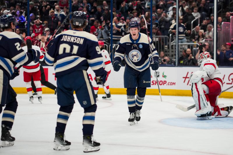 Nov 23, 2024; Columbus, Ohio, USA;  Columbus Blue Jackets left wing Dmitri Voronkov (10) celebrates with teammates after scoring a goal against the Carolina Hurricanes in the second period at Nationwide Arena. Mandatory Credit: Aaron Doster-Imagn Images