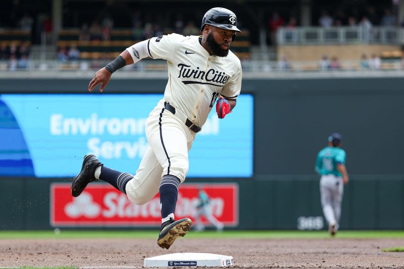 May 9, 2024; Minneapolis, Minnesota, USA; Minnesota Twins Manuel Margot (13) scores on a single hit by Carlos Santana (30) against the Seattle Mariners during the first inning at Target Field. Mandatory Credit: Matt Krohn-USA TODAY Sports