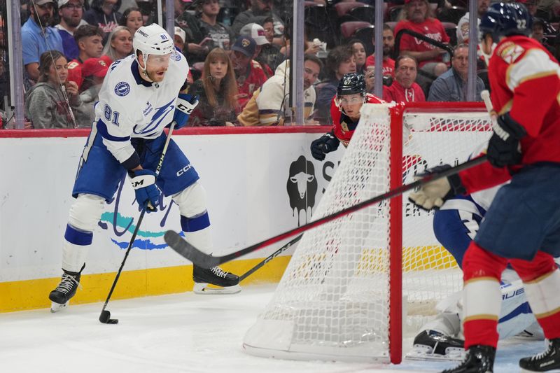 Sep 30, 2024; Sunrise, Florida, USA; Tampa Bay Lightning defenseman Erik Cernak (81) looks to clear the puck against the Florida Panthers during the second period at Amerant Bank Arena. Mandatory Credit: Jim Rassol-Imagn Images