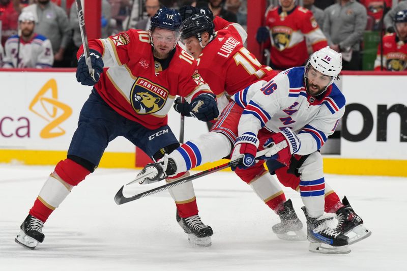 Jun 1, 2024; Sunrise, Florida, USA; New York Rangers center Vincent Trocheck (16) collides with Florida Panthers center Anton Lundell (15) and right wing Vladimir Tarasenko (10) during the first period in game six of the Eastern Conference Final of the 2024 Stanley Cup Playoffs at Amerant Bank Arena. Mandatory Credit: Jim Rassol-USA TODAY Sports