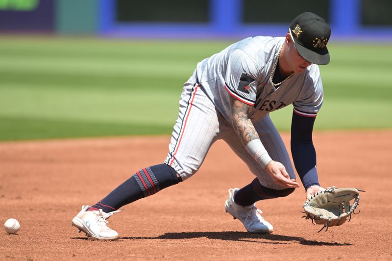 May 19, 2024; Cleveland, Ohio, USA; Minnesota Twins third baseman Jose Miranda (64) misplays a ball hit Cleveland Guardians center fielder Tyler Freeman (not pictured) during the first inning at Progressive Field. Mandatory Credit: Ken Blaze-USA TODAY Sports