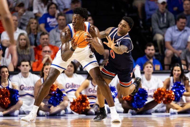 Feb 10, 2024; Gainesville, Florida, USA; Florida Gators forward Tyrese Samuel (4) controls the ball against Auburn Tigers guard K.D. Johnson (0) during the first half at Exactech Arena at the Stephen C. O'Connell Center. Mandatory Credit: Matt Pendleton-USA TODAY Sports