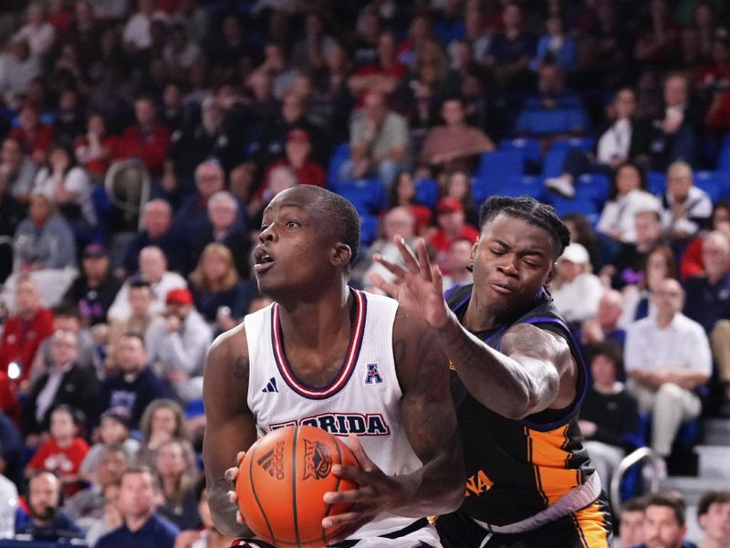 Jan 2, 2024; Boca Raton, Florida, USA; Florida Atlantic Owls guard Johnell Davis (1) drives to the basket against the East Carolina Pirates during the second half at Eleanor R. Baldwin Arena. Mandatory Credit: Rich Storry-USA TODAY Sports