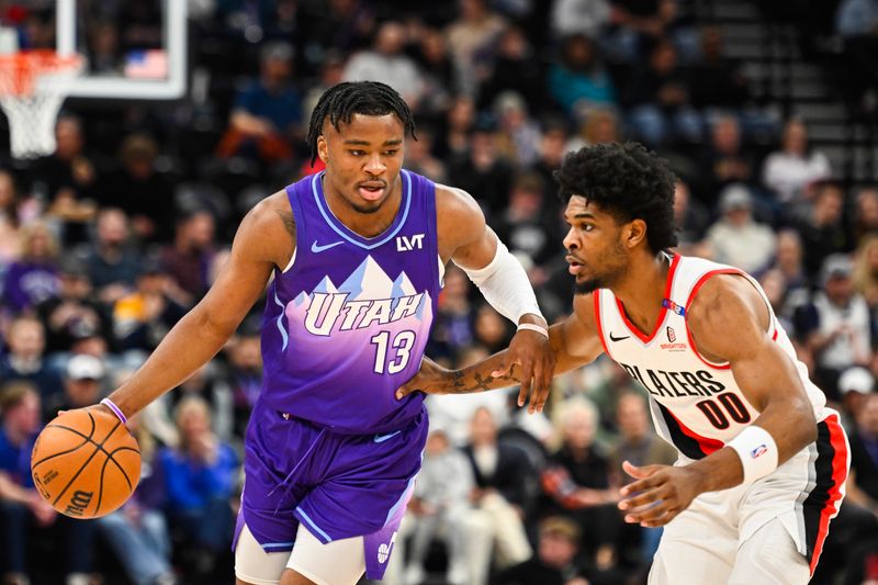 SALT LAKE CITY, UTAH - FEBRUARY 24: Isaiah Collier #13 of the Utah Jazz drives into Scoot Henderson #00 of the Portland Trail Blazers during the first half of a game at Delta Center on February 24, 2025 in Salt Lake City, Utah. NOTE TO USER: User expressly acknowledges and agrees that, by downloading and or using this photograph, User is consenting to the terms and conditions of the Getty Images License Agreement. (Photo by Alex Goodlett/Getty Images)