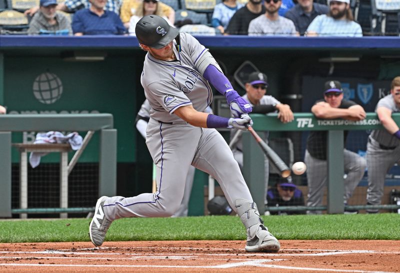 Apr 24, 2025; Kansas City, Missouri, USA;  Colorado Rockies catcher Hunter Goodman (15) drives in a run with a single in the first inning against the Kansas City Royals at Kauffman Stadium. Mandatory Credit: Peter Aiken-Imagn Images