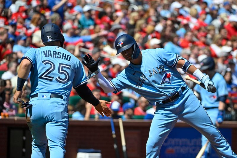 Apr 2, 2023; St. Louis, Missouri, USA;  Toronto Blue Jays center fielder Daulton Varsho (25) is congratulated by left fielder Whit Merrifield (15) after scoring against the St. Louis Cardinals during the second inning at Busch Stadium. Mandatory Credit: Jeff Curry-USA TODAY Sports