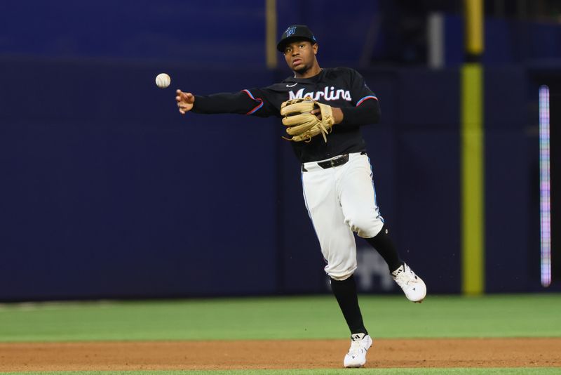 Jul 5, 2024; Miami, Florida, USA; Miami Marlins shortstop Xavier Edwards (63) throws to first base to retire Chicago White Sox designated hitter Eloy Jimenez (not pictured) during the seventh inning at loanDepot Park. Mandatory Credit: Sam Navarro-USA TODAY Sports
