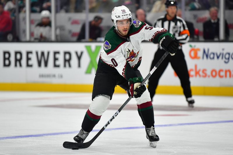 Oct 5, 2023; Anaheim, California, USA; Arizona Coyotes defenseman Sean Durzi (50) controls the puck against the Anaheim Ducks during the third period at Honda Center. Mandatory Credit: Gary A. Vasquez-USA TODAY Sports