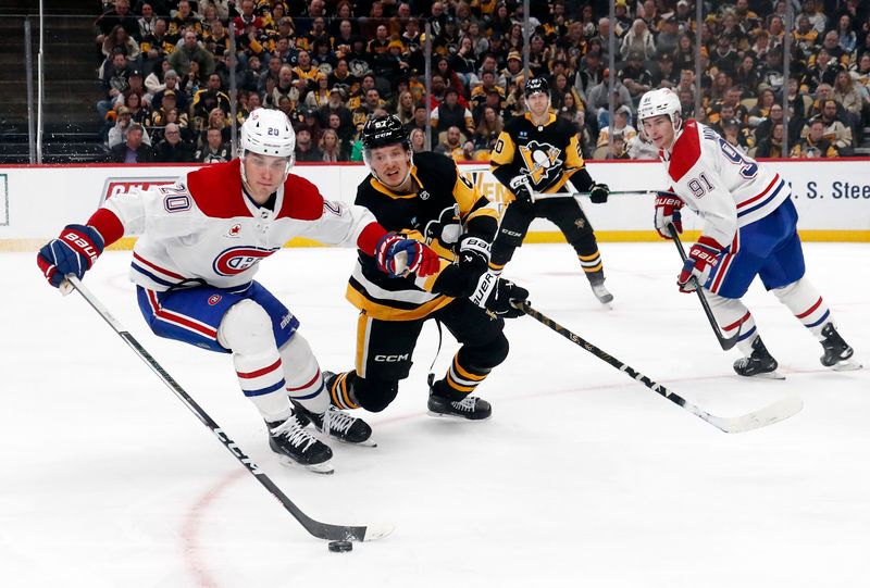 Jan 27, 2024; Pittsburgh, Pennsylvania, USA;  Montreal Canadiens left wing Juraj Slafkovsky (20) clears the puck ahead of Pittsburgh Penguins right wing Rickard Rakell (67) during the third period at PPG Paints Arena. The Penguins won 3-2 in overtime. Mandatory Credit: Charles LeClaire-USA TODAY Sports