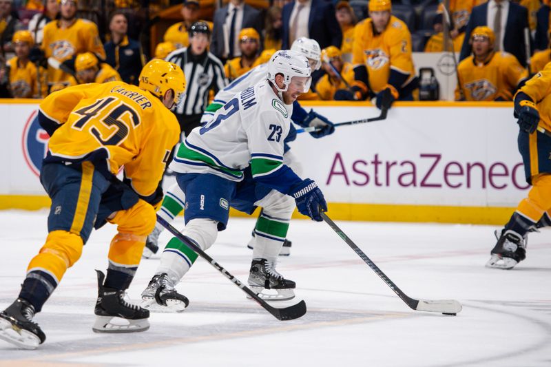 Apr 26, 2024; Nashville, Tennessee, USA; Vancouver Canucks center Elias Lindholm (23) skates against the Nashville Predator during the second period in game three of the first round of the 2024 Stanley Cup Playoffs at Bridgestone Arena. Mandatory Credit: Steve Roberts-USA TODAY Sports