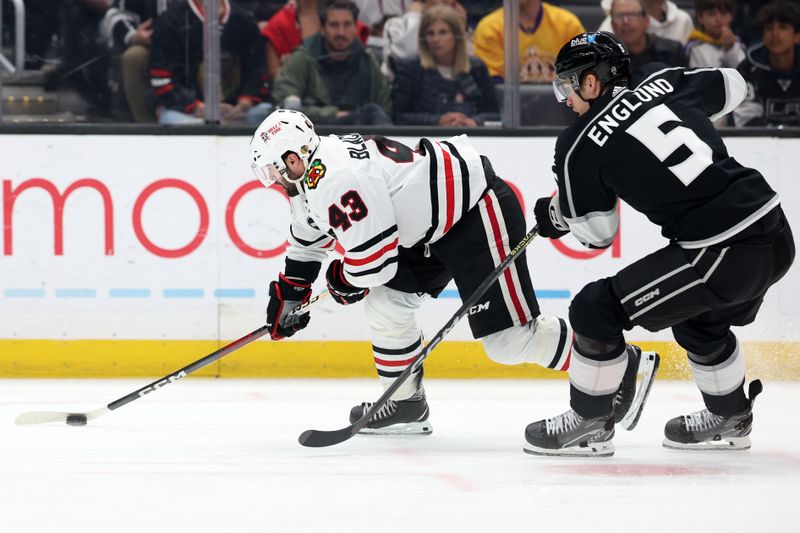 Mar 19, 2024; Los Angeles, California, USA;  Chicago Blackhawks center Colin Blackwell (43) skates with the puck against Los Angeles Kings defenseman Andreas Englund (5) during the first period at Crypto.com Arena. Mandatory Credit: Kiyoshi Mio-USA TODAY Sports