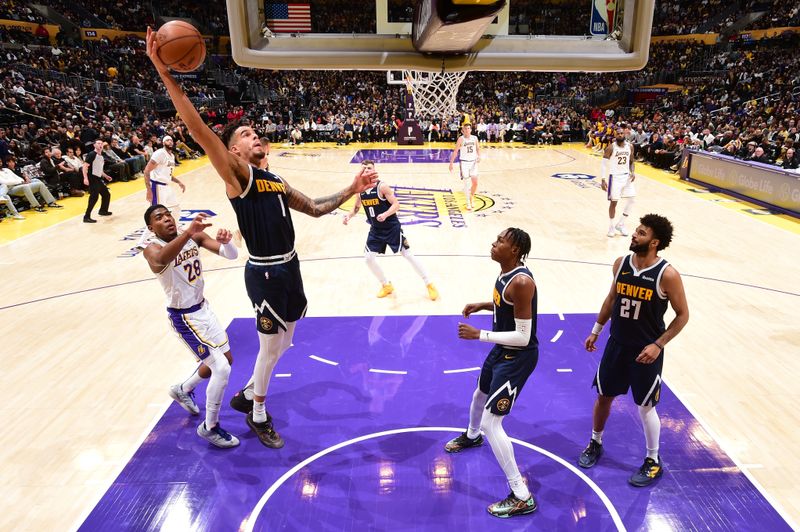 LOS ANGELES, CA - NOVEMBER 23: Michael Porter Jr. #1 of the Denver Nuggets rebounds the ball during the game against the Los Angeles Lakers on November 23, 2024 at Crypto.Com Arena in Los Angeles, California. NOTE TO USER: User expressly acknowledges and agrees that, by downloading and/or using this Photograph, user is consenting to the terms and conditions of the Getty Images License Agreement. Mandatory Copyright Notice: Copyright 2024 NBAE (Photo by Adam Pantozzi/NBAE via Getty Images)