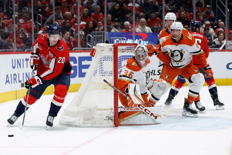 Jan 14, 2025; Washington, District of Columbia, USA; Washington Capitals center Lars Eller (20) skates with the puck behind Anaheim Ducks goaltender John Gibson (36) in the third period at Capital One Arena. Mandatory Credit: Geoff Burke-Imagn Images