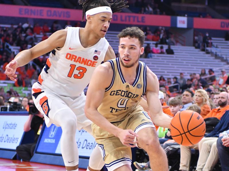 Feb 28, 2023; Syracuse, New York, USA; Georgia Tech Yellow Jackets guard Lance Terry (0) moves the ball past Syracuse Orange forward Benny Williams (13) in the first half at the JMA Wireless Dome. Mandatory Credit: Mark Konezny-USA TODAY Sports