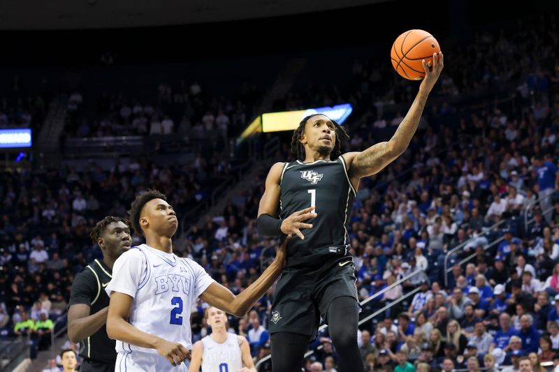 Feb 13, 2024; Provo, Utah, USA; Central Florida Knights guard Antwann Jones (1) lays the ball up against the Brigham Young Cougars during the first half at Marriott Center. Mandatory Credit: Rob Gray-USA TODAY Sports