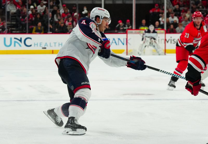 Nov 26, 2023; Raleigh, North Carolina, USA;  Columbus Blue Jackets center Cole Sillinger (4) watches his shot against the Carolina Hurricanes during the second period at PNC Arena. Mandatory Credit: James Guillory-USA TODAY Sports