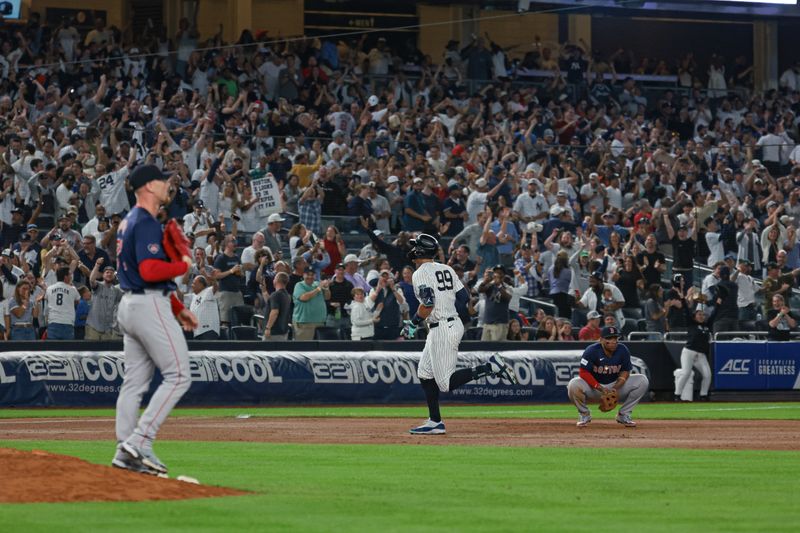 Sep 13, 2024; Bronx, New York, USA; New York Yankees center fielder Aaron Judge (99) celebrates while running the bases after hitting a grand slam home run during the seventh inning against Boston Red Sox relief pitcher Cam Booser (71) at Yankee Stadium. Mandatory Credit: Vincent Carchietta-Imagn Images