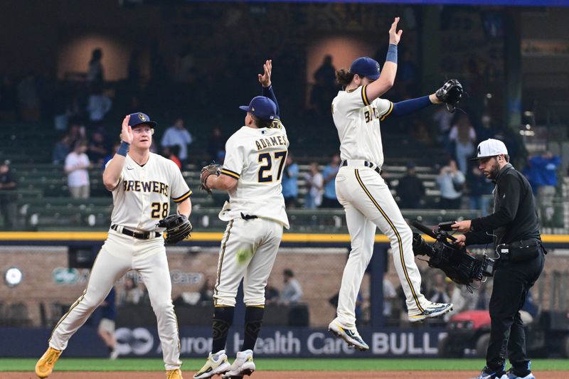 May 24, 2023; Milwaukee, Wisconsin, USA; Milwaukee Brewers center fielder Joey Wiemer (28), shortstop Willy Adames (27) and right fielder Brian Anderson (9) celebrate after beating the Houston Astros at American Family Field. Mandatory Credit: Benny Sieu-USA TODAY Sports