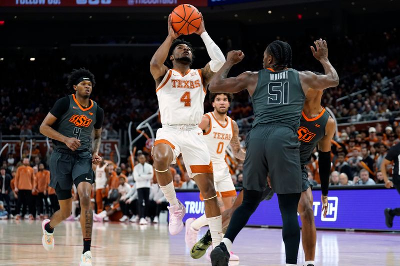 Jan 24, 2023; Austin, Texas, USA; Texas Longhorns 04 guard Tyrese Hunter (4) shoots over Oklahoma State Cowboys guard John-Michael Wright (13) during the first half at Moody Center. Mandatory Credit: Scott Wachter-USA TODAY Sports