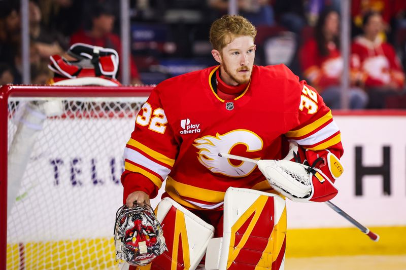 Oct 3, 2025; Calgary, Alberta, CAN; Calgary Flames goaltender Dustin Wolf (32) reacts during the first period against the Winnipeg Jets at Scotiabank Saddledome. Mandatory Credit: Sergei Belski-Imagn Images