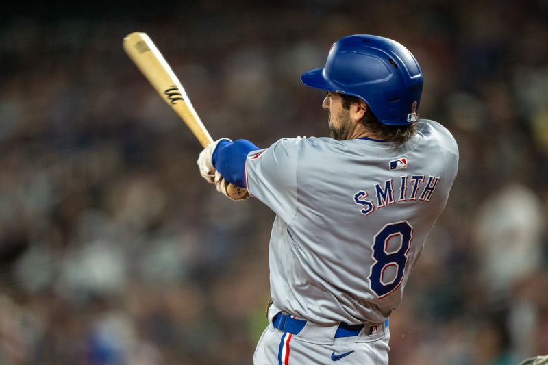 Sep 13, 2024; Seattle, Washington, USA;  Texas Rangers shortstop Josh Smith (8) hits a single during the first inning against the Seattle Mariners at T-Mobile Park. Mandatory Credit: Stephen Brashear-Imagn Images