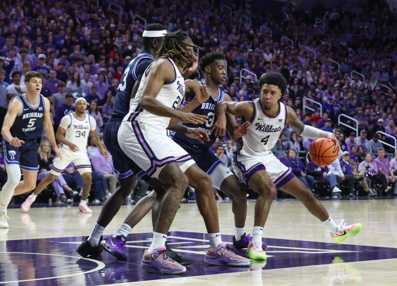 Jan 3, 2026; Manhattan, Kansas, USA; Kansas State Wildcats guard P.J. Haggerty (4) is guarded by Brigham Young Cougars forward AJ Dybantsa (3) during the second half at Bramlage Coliseum. Mandatory Credit: Scott Sewell-Imagn Images