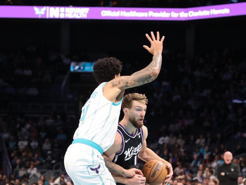 CHARLOTTE, NC - JANUARY 10: Domantas Sabonis #10 of the Sacramento Kings handles the ball during the game against the Charlotte Hornets on January  10, 2024 at Spectrum Center in Charlotte, North Carolina. NOTE TO USER: User expressly acknowledges and agrees that, by downloading and or using this photograph, User is consenting to the terms and conditions of the Getty Images License Agreement.  Mandatory Copyright Notice:  Copyright 2024 NBAE (Photo by Brock Williams-Smith/NBAE via Getty Images) 