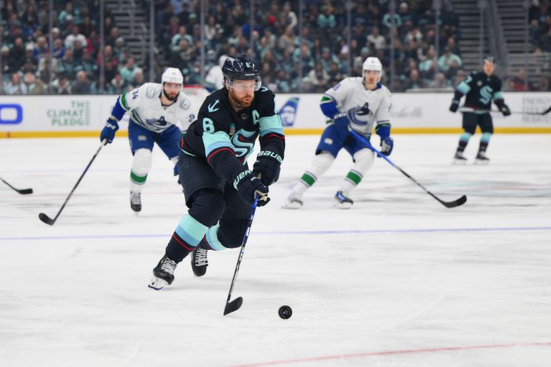 Nov 24, 2023; Seattle, Washington, USA; Seattle Kraken defenseman Adam Larsson (6) advances the puck against the Vancouver Canucks during the first period at Climate Pledge Arena. Mandatory Credit: Steven Bisig-USA TODAY Sports