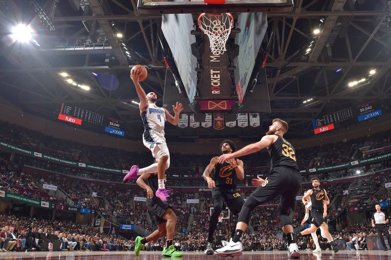 CLEVELAND, OH - NOVEMBER 1: Jalen Suggs #4 of the Orlando Magic drives to the basket during the game against the Cleveland Cavaliers on November 1, 2024 at Rocket Mortgage FieldHouse in Cleveland, Ohio. NOTE TO USER: User expressly acknowledges and agrees that, by downloading and/or using this Photograph, user is consenting to the terms and conditions of the Getty Images License Agreement. Mandatory Copyright Notice: Copyright 2024 NBAE (Photo by David Liam Kyle/NBAE via Getty Images)