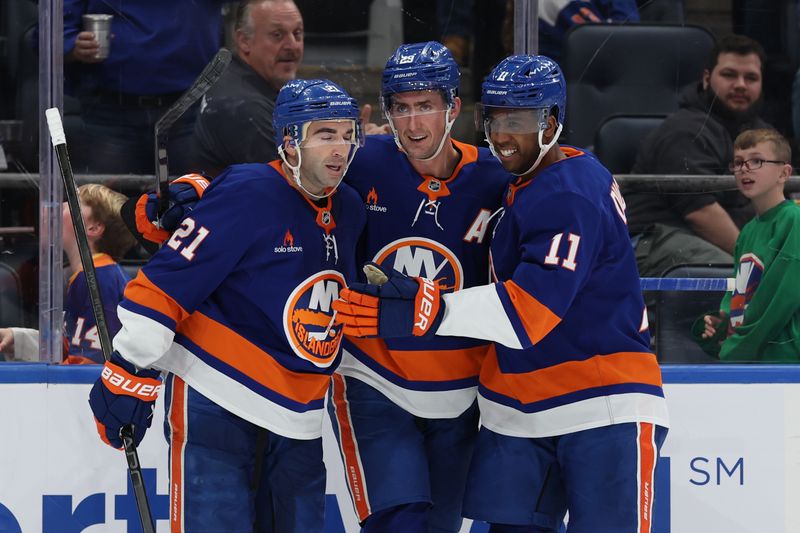 Jan 18, 2025; Elmont, New York, USA; New York Islanders center Kyle Palmieri (21) and left wing Anthony Duclair (11) celebrate New York Islanders center Brock Nelson (29) goal against the San Jose Sharks during the second period at UBS Arena. Mandatory Credit: Thomas Salus-Imagn Images