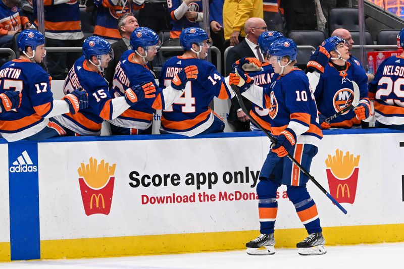 Apr 17, 2024; Elmont, New York, USA;  New York Islanders right wing Simon Holmstrom (10) celebrates his goal against the Pittsburgh Penguins with the bench during the third period at UBS Arena. Mandatory Credit: Dennis Schneidler-USA TODAY Sports