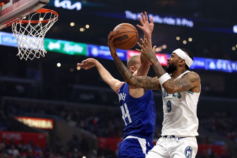 LOS ANGELES, CALIFORNIA - FEBRUARY 12: Nickeil Alexander-Walker #9 of the Minnesota Timberwolves drives to the basket against Mason Plumlee #44 of the Los Angeles Clippers during the first quarter at Crypto.com Arena on February 12, 2024 in Los Angeles, California. NOTE TO USER: User expressly acknowledges and agrees that, by downloading and or using this photograph, user is consenting to the terms and conditions of the Getty Images License Agreement. (Photo by Katelyn Mulcahy/Getty Images)