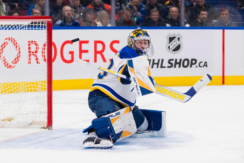 Jan 24, 2024; Vancouver, British Columbia, CAN; St. Louis Blues goalie Joel Hofer (30) makes a save against the Vancouver Canucks in the third period at Rogers Arena. Blues 4-3 in overtime. Mandatory Credit: Bob Frid-USA TODAY Sports