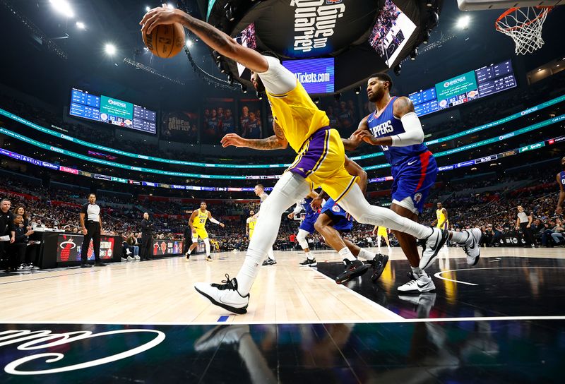 LOS ANGELES, CALIFORNIA - JANUARY 23:  Anthony Davis #3 of the Los Angeles Lakers controls the ball against Paul George #13 of the LA Clippers in the second half at Crypto.com Arena on January 23, 2024 in Los Angeles, California.  NOTE TO USER: User expressly acknowledges and agrees that, by downloading and/or using this photograph, user is consenting to the terms and conditions of the Getty Images License Agreement.  (Photo by Ronald Martinez/Getty Images)