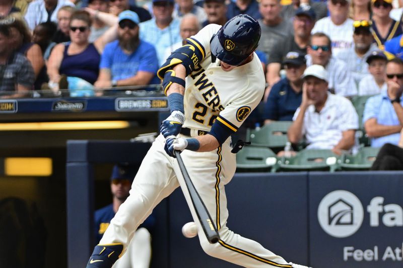 Aug 9, 2023; Milwaukee, Wisconsin, USA; Milwaukee Brewers designated hitter Christian Yelich (22) singles to drive in a run against the Colorado Rockies in the fourth inning at American Family Field. Mandatory Credit: Benny Sieu-USA TODAY Sports