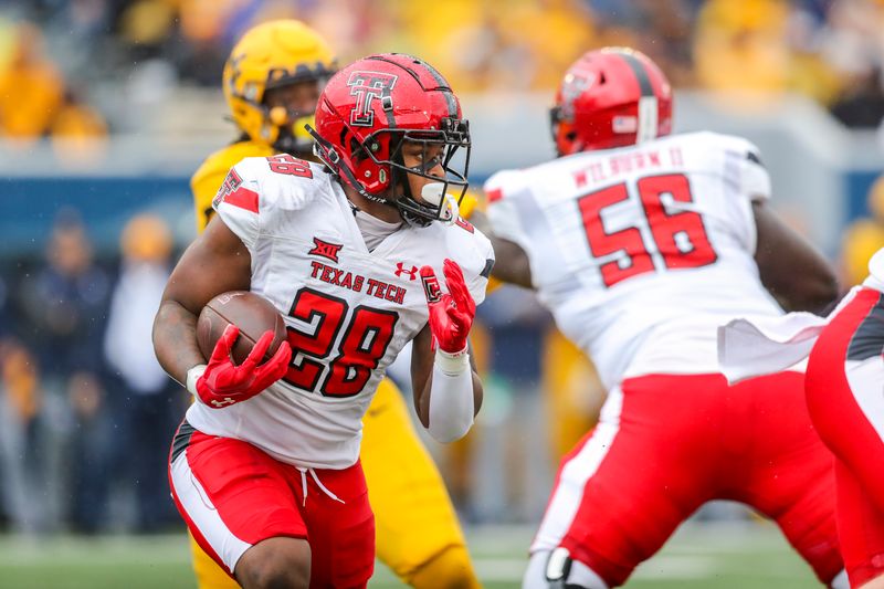 Sep 23, 2023; Morgantown, West Virginia, USA; Texas Tech Red Raiders running back Tahj Brooks (28) runs the ball against the West Virginia Mountaineers during the second quarter at Mountaineer Field at Milan Puskar Stadium. Mandatory Credit: Ben Queen-USA TODAY Sports