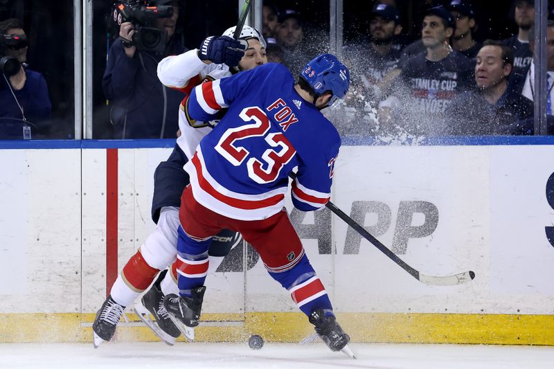 May 22, 2024; New York, New York, USA; Florida Panthers left wing Ryan Lomberg (94) collides with New York Rangers defenseman Adam Fox (23) during the second period of game one of the Eastern Conference Final of the 2024 Stanley Cup Playoffs at Madison Square Garden. Mandatory Credit: Brad Penner-USA TODAY Sports