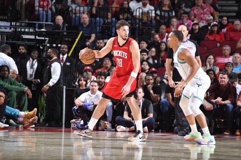 HOUSTON, TX - OCTOBER 23:  Alperen Sengun #28 of the Houston Rockets looks to pass the ball during the game against the Charlotte Hornets  during a regular season game on October 23, 2024 at the Toyota Center in Houston, Texas. NOTE TO USER: User expressly acknowledges and agrees that, by downloading and or using this photograph, User is consenting to the terms and conditions of the Getty Images License Agreement. Mandatory Copyright Notice: Copyright 2024 NBAE (Photo by Logan Riely/NBAE via Getty Images)