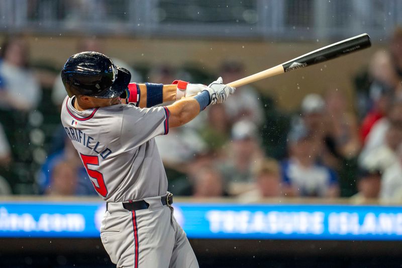 Aug 26, 2024; Minneapolis, Minnesota, USA; Atlanta Braves second baseman Whit Merrifield (15) hits a single against the Minnesota Twins in the third inning at Target Field. Mandatory Credit: Jesse Johnson-USA TODAY Sports