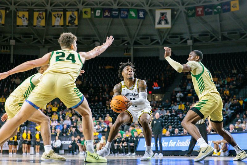 Jan 14, 2025; Wichita, Kansas, USA; Wichita State Shockers guard Justin Hill (11) looks to shoots the ball around Charlotte 49ers forward Rich Rolf (24) during the second half at Charles Koch Arena. Mandatory Credit: William Purnell-Imagn Images