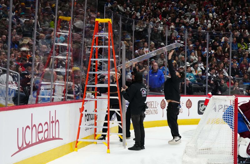 Dec 31, 2023; Denver, Colorado, USA; Ball Arena conversion team makes rink glass repairs during the first period between the San Jose Sharks against the Colorado Avalanche. Mandatory Credit: Ron Chenoy-USA TODAY Sports