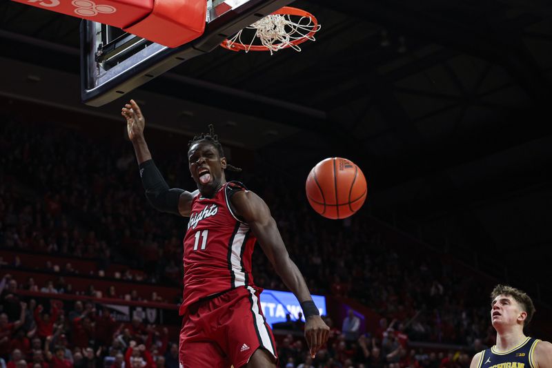 Feb 29, 2024; Piscataway, New Jersey, USA; Rutgers Scarlet Knights center Clifford Omoruyi (11) reacts after a dunk during the second half against the Michigan Wolverines at Jersey Mike's Arena. Mandatory Credit: Vincent Carchietta-USA TODAY Sports