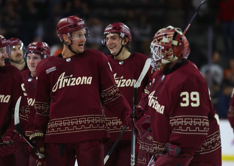 Nov 30, 2023; Tempe, Arizona, USA; Arizona Coyotes center Nick Bjugstad (17) celebrates with teammates after scoring the winning goal against the Colorado Avalanche in overtime at Mullett Arena. Mandatory Credit: Mark J. Rebilas-USA TODAY Sports