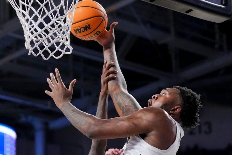 Dec 19, 2023; Cincinnati, Ohio, USA; Cincinnati Bearcats forward Jamille Reynolds (13) attempts a dunk as he is fouled by Merrimack Warriors guard Devon Savage (5) in the first half at Fifth Third Arena. Mandatory Credit: Aaron Doster-USA TODAY Sports