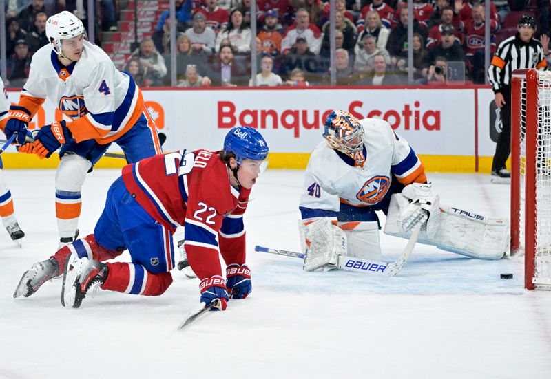 Jan 25, 2024; Montreal, Quebec, CAN; Montreal Canadiens forward Cole Caufield (22) scores a goal against New York Islanders goalie Semyon Varlamov (40) during the first period at the Bell Centre. Mandatory Credit: Eric Bolte-USA TODAY Sports